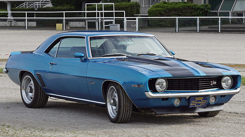 A wide angle shot of the front end of a 1969 Chevy Camaro Z/28 parked in a parking lot