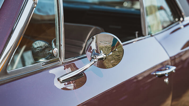 The interior of a burgundy 1967 Chevy Chevelle